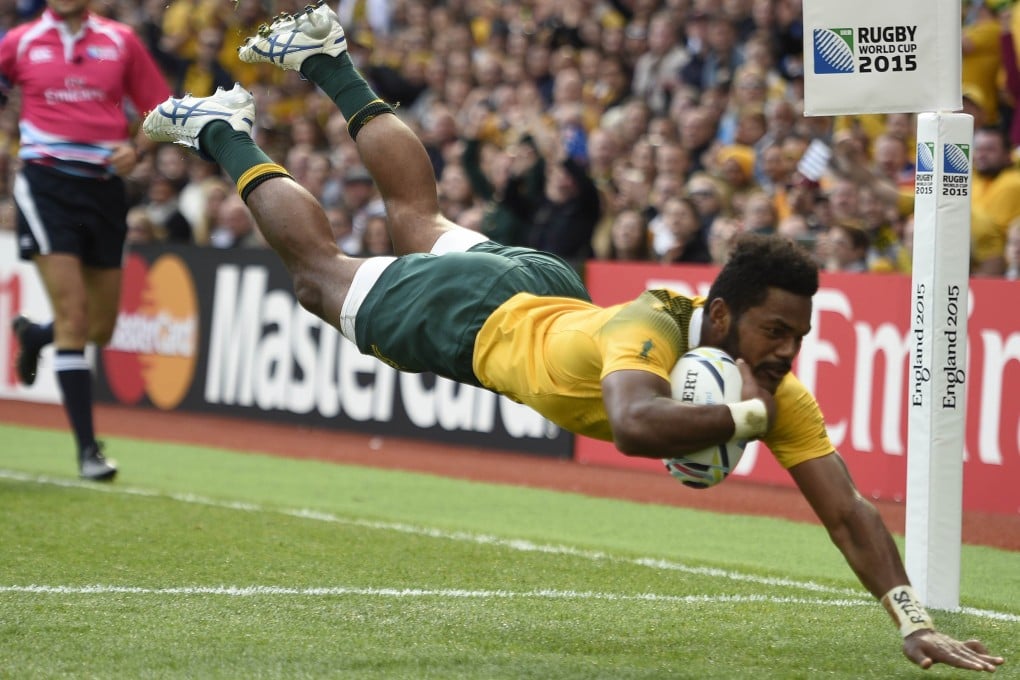 Australia's wing Henry Speight dives in to score Australia's fourth try against Uruguay. Photo: AFP