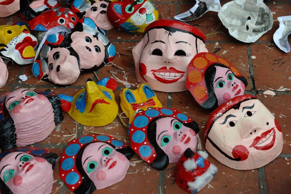 Vu Thi Thoan's family has been making papier mache masks, part of traditional Vietnamese celebrations for the mid-autumn festival, for over four decades. But cheap Chinese toys are threatening her business. Photo: AFP