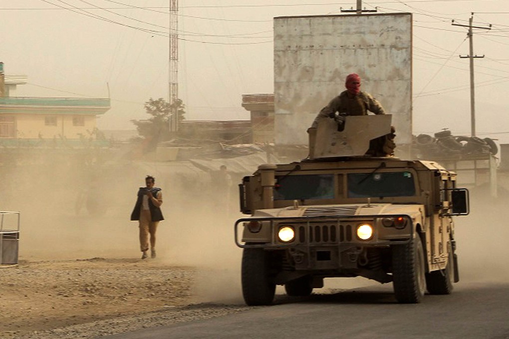 Afghan security forces travel in a Humvee vehicle, as battles continue with Taliban militants in Kunduz. Photo: AFP