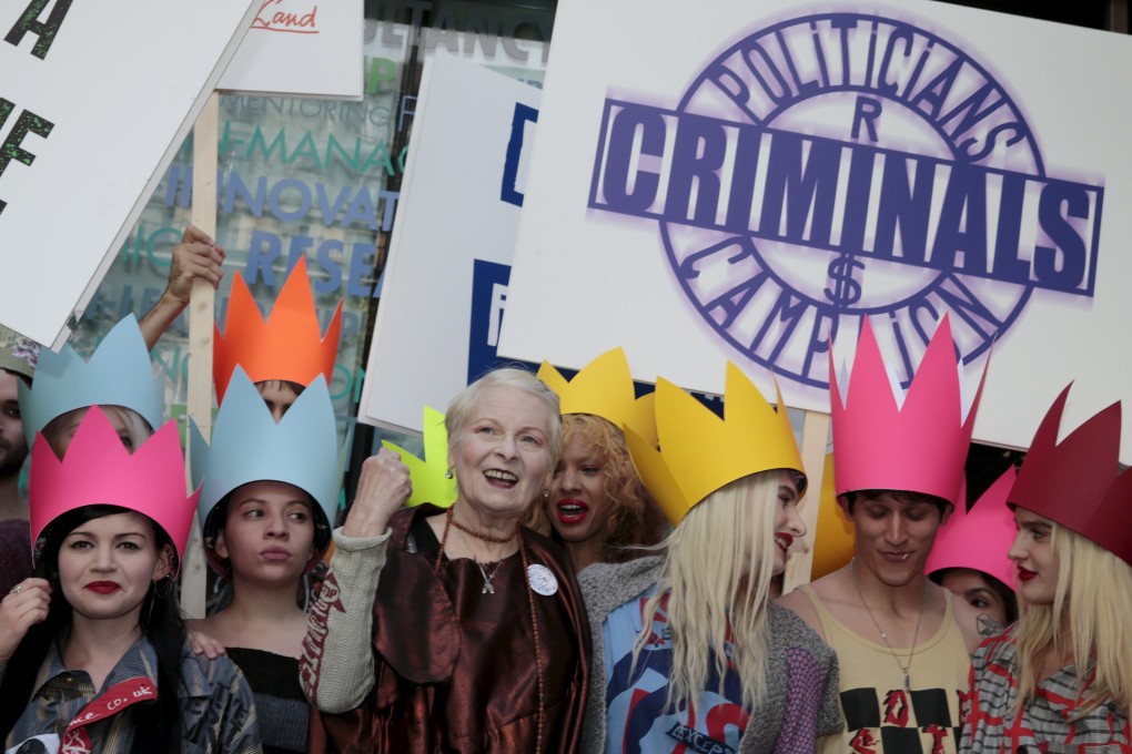 Vivienne Westwood arrives with placard-bearing activists before presenting her Red Label spring/summer 2016 collection. Photo: Reuters