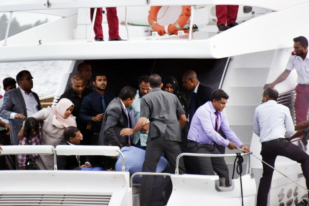 Unidentified injured people are evacuated from Maldives President Yameen Abdul Gayoom's boat in Male on Monday, after an explosion rocked the vessel. Photo: AP