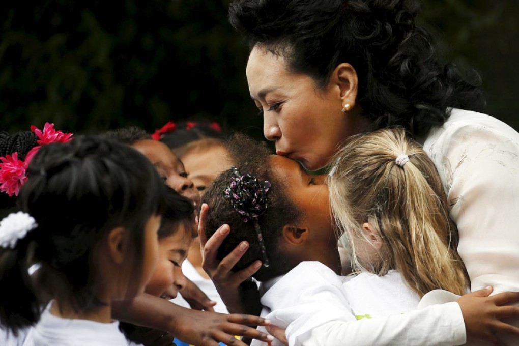 Peng kisses a girl from Washington's Yu Ying Public Charter School. Photo: Reuters