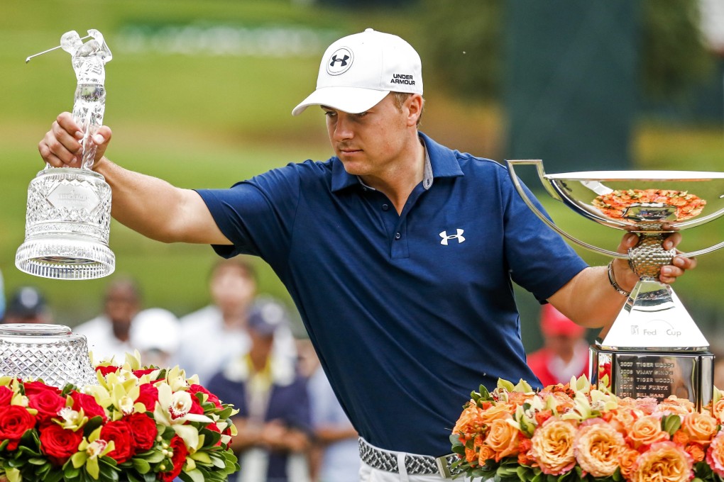 Jordan Spieth celebrates with the Tour Championship trophy and the FedEx Cup. Photo: EPA