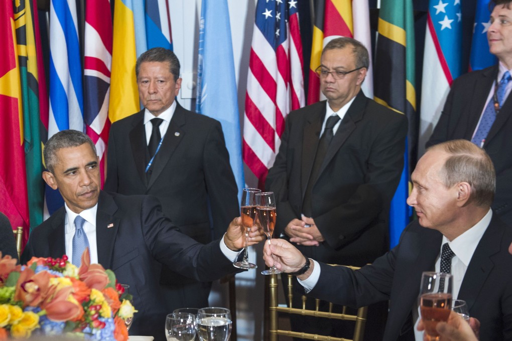 Barack Obama and Vladimir Putin clink glasses at a lunch hosted by the UN Secretary-General Ban Ki-moon on Monday. Photo: AFP