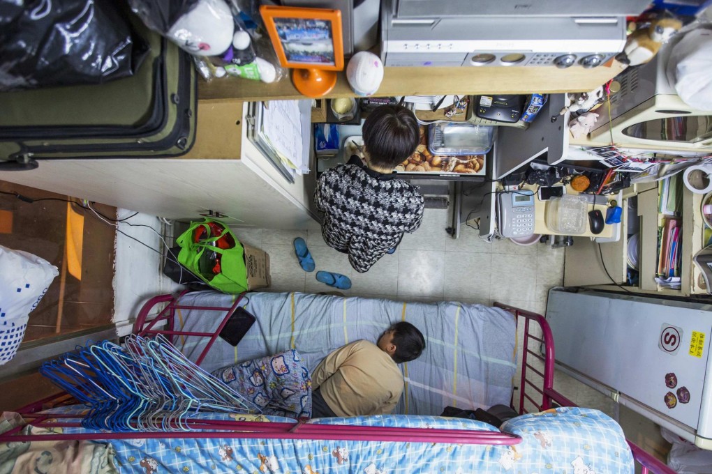 A woman and her son in a subdivided flat. About 1.34 million Hong Kong people live below the poverty line.Photo: Reuters