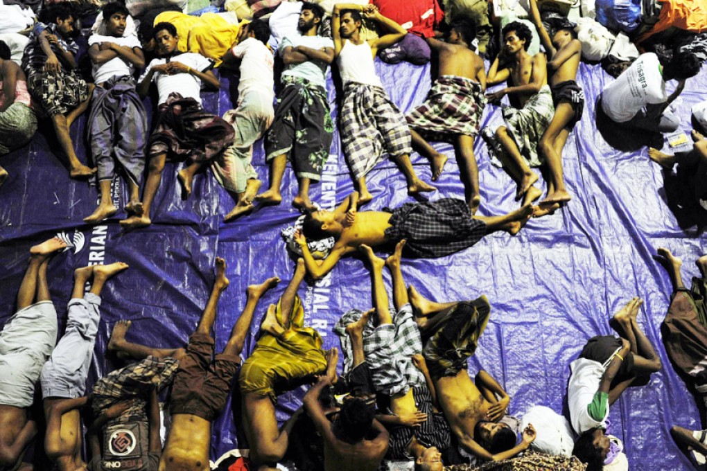 Rohingya refugees rest inside a shelter after being rescued from boats at Lhoksukon in Indonesia's Aceh Province in May. Photo: Reuters