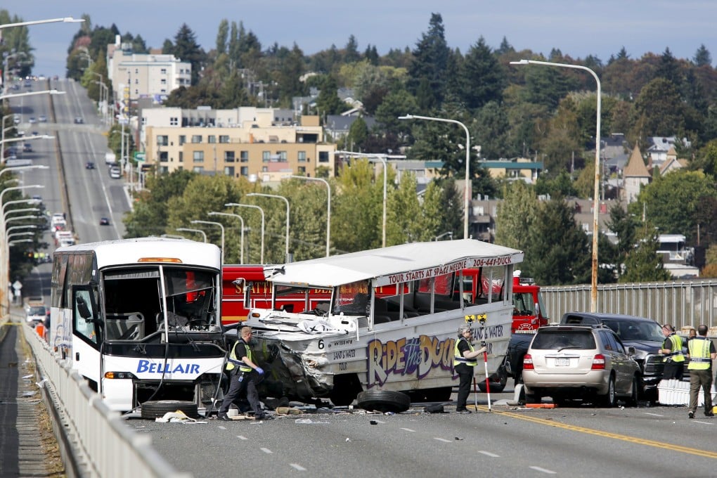 Investigators are pictured at the scene of last week's crash between a Ride the Ducks vehicle and a charter bus on the Aurora Bridge in Seattle. Photo: Reuters
