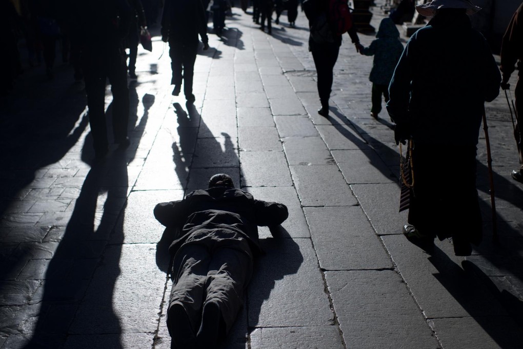 A Buddhist performs prostrations in Lhasa, Tibet. The ideas of our time cultivate the soul, organise the intellect and animate the will. Photo: Xinhua