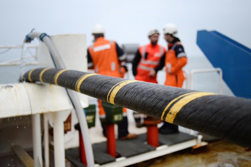 Workers install an electric submarine cable and optical fibre between Quiberon and Belle-Ile-en-mer, western France. Photo: AFP