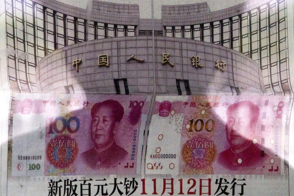 A shadow of a man is reflected on a glass while the image of the People's Bank of China looms in the background. Photo: AP