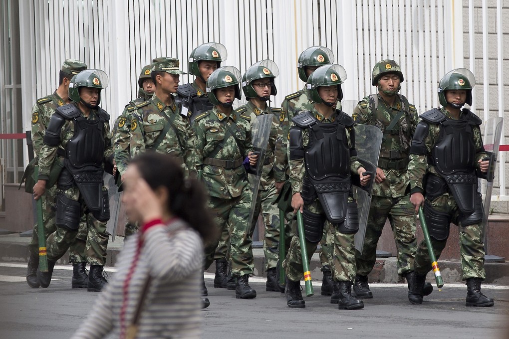 Paramilitary policemen with shields and batons patrol near People's Square in Urumqi, China's northwestern region of Xinjiang, in this file photo. Photo: AP