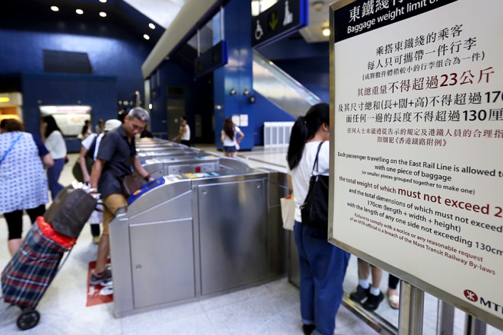 Passengers carry over sized luggages on MTR is seen at Tai Wai Station. Photo: Edward Wong