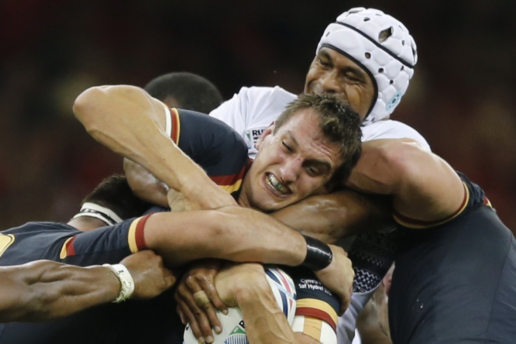 Fiji get to grips with Sam Warburton. Photo: AP