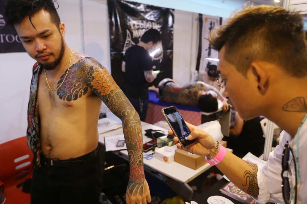 Tattoo artists work on their clients at the International Tattoo Convention yesterday. Photo: Sam Tsang