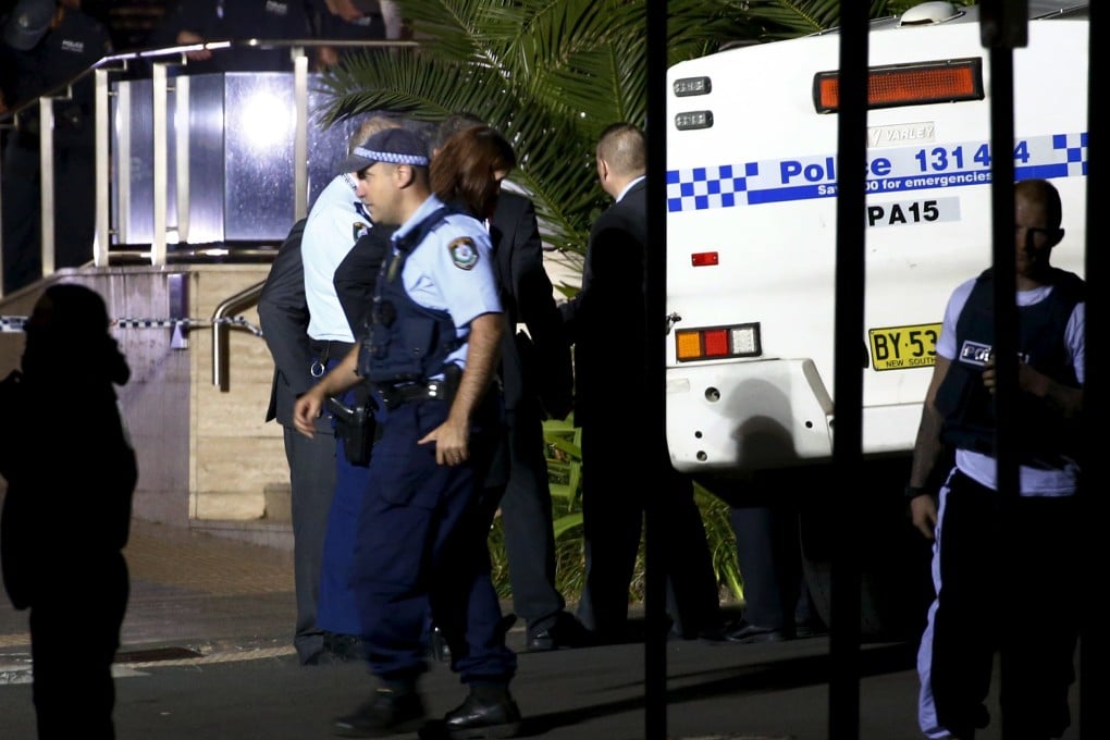 Police inspect and guard the area outside the New South Wales state police headquarters located in the south western Sydney suburb of Parramatta. Photo: Reuters