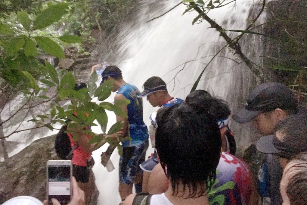 Runners pass a stream that has turned into a torrent