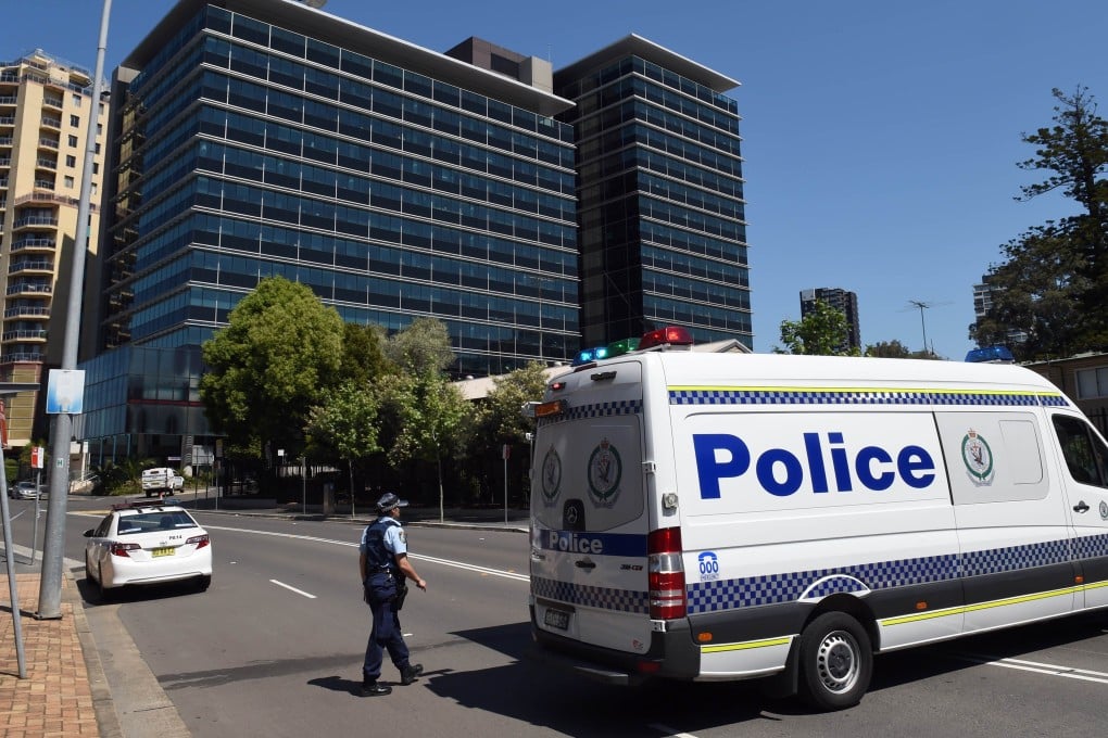 Police block off the scene near New South Wales Police Headquarters where a 15-year-old gunman shot dead a civilian police employee in Sydney. Photo: AFP