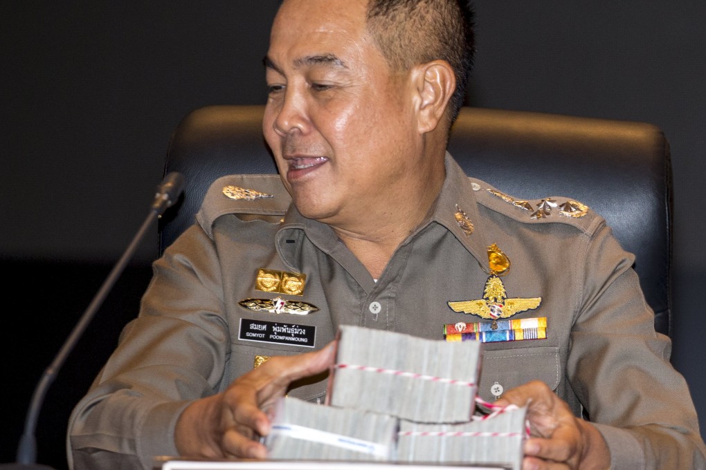 Thai national police chief Somyot Pumpanmuang holds up a reward before a news conference about the Bangkok blast. Photo: Reuters