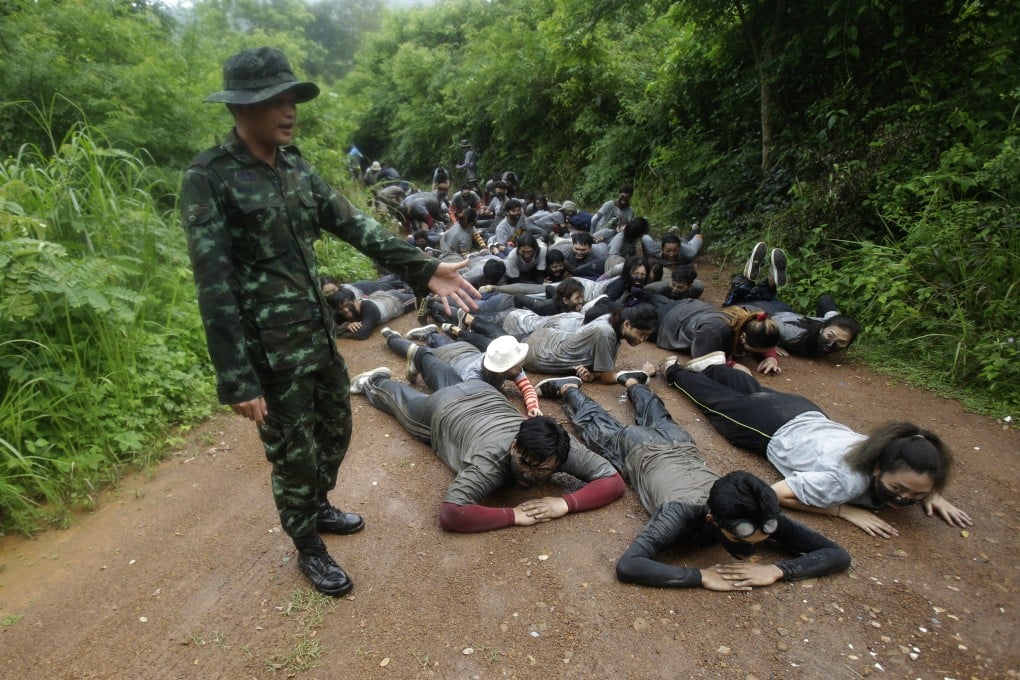 The students are made to crawl on their stomachs through muddy jungle paths as part of an endurance test designed to "break down their ego (and) humiliate them".  Photo: AP