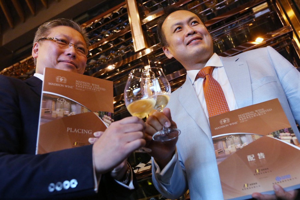 Madison (China) Limited director Samuel Lin (left) and deputy chairman Kao Sheng-chi toast the IPO announcement yesterday. Photo: Nora Tam