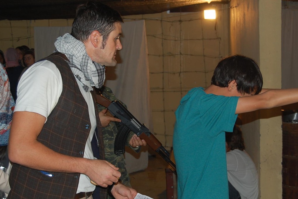 David Begbie interrogates a student during a Refugee Run simulation. Photos: Edward Wong