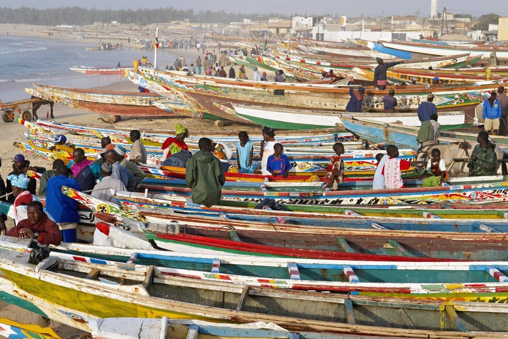 Fishing boats pulled up on the beach in Kayar, Senegal. Photo: Corbis
