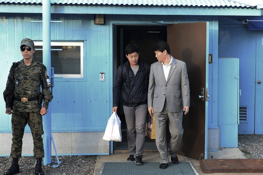 South Korean Joo Won-moon, who has a permanent resident status in the United States, is escorted by a South Korean official at the border village of Panmunjom. Photo: The South Korean Unification Ministry via AP