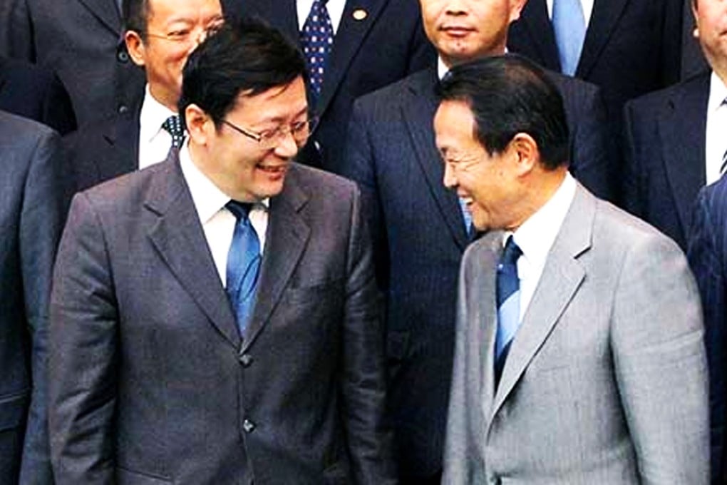 China's Lou Jiwei (left) and Japan's Finance Minister Taro Aso discussed cooperation on economic, financial and international affairs at the Fifth China-Japan Finance Dialogue in June. Photo: SCMP Pictures