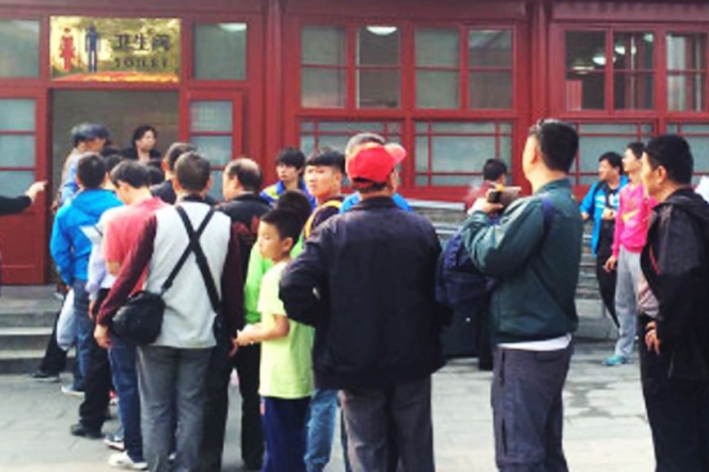 Men queue up to use the toilet at Beijing's Forbidden City during the current National Day holiday. Photo: SCMP Pictures