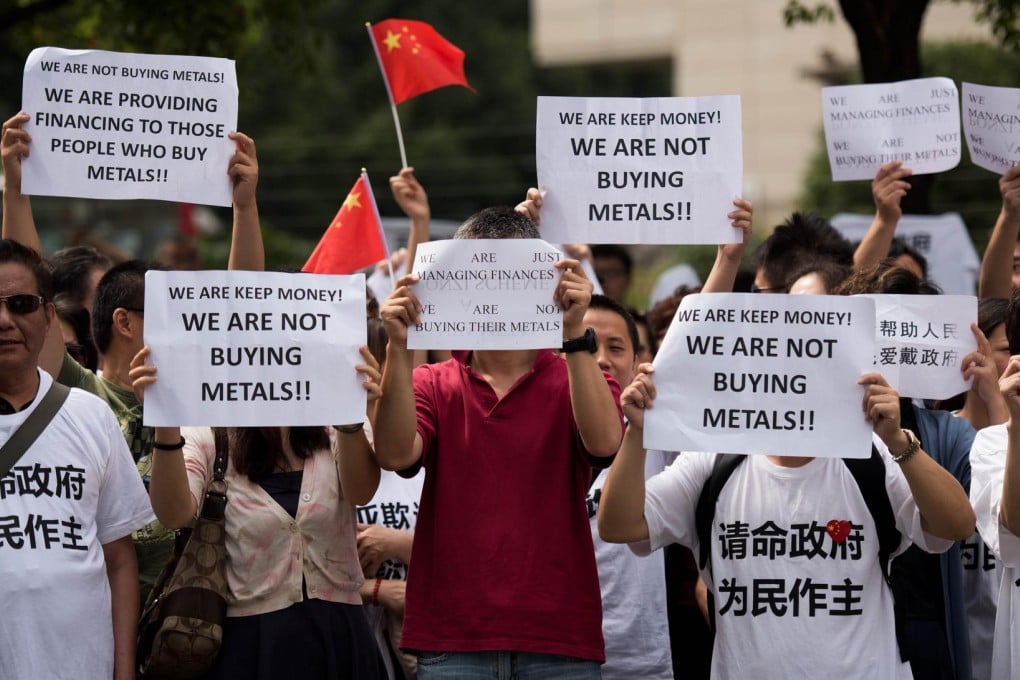 Disgruntled investors protest in Shanghai last month over losses they say are the fault of the Fanya exchange. Photos: AFP