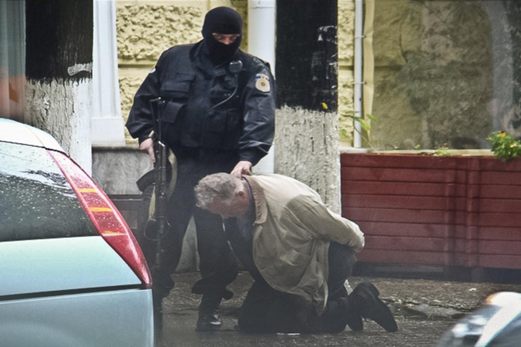 A go-between is detained in a 2011 Moldova sting operation. Photo: AP