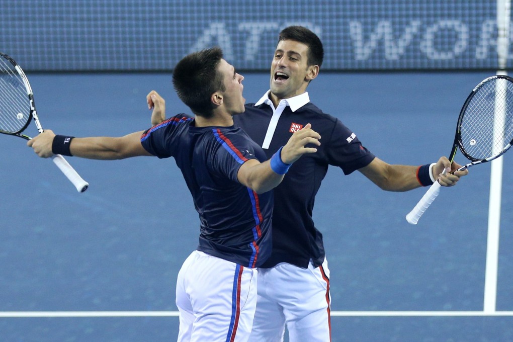The Djokovic brothers celebrate a point. Photo: EPA