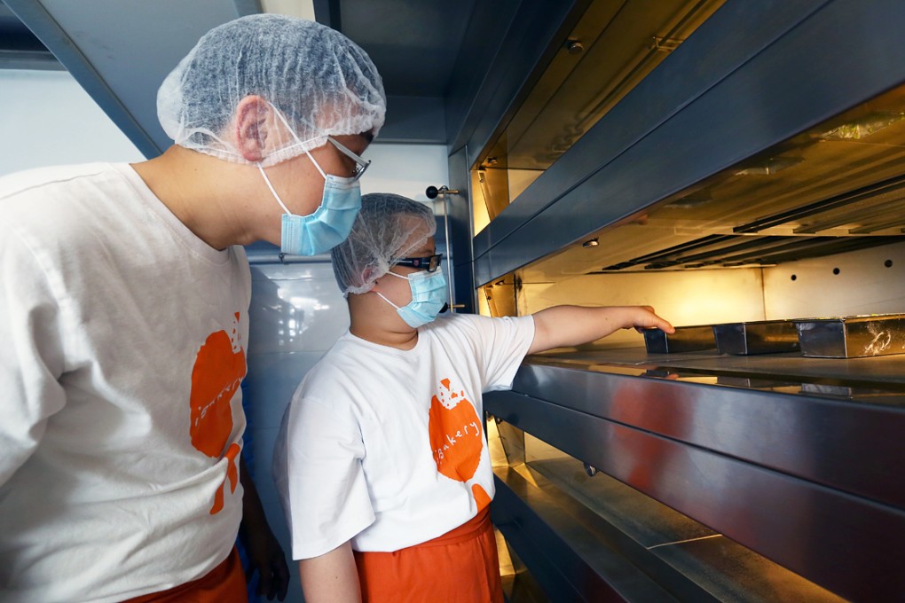 Bakery worker and his supervisor of iBakery Production and Training Centre make a green tea cake at the bakery. Photo: Edmond So