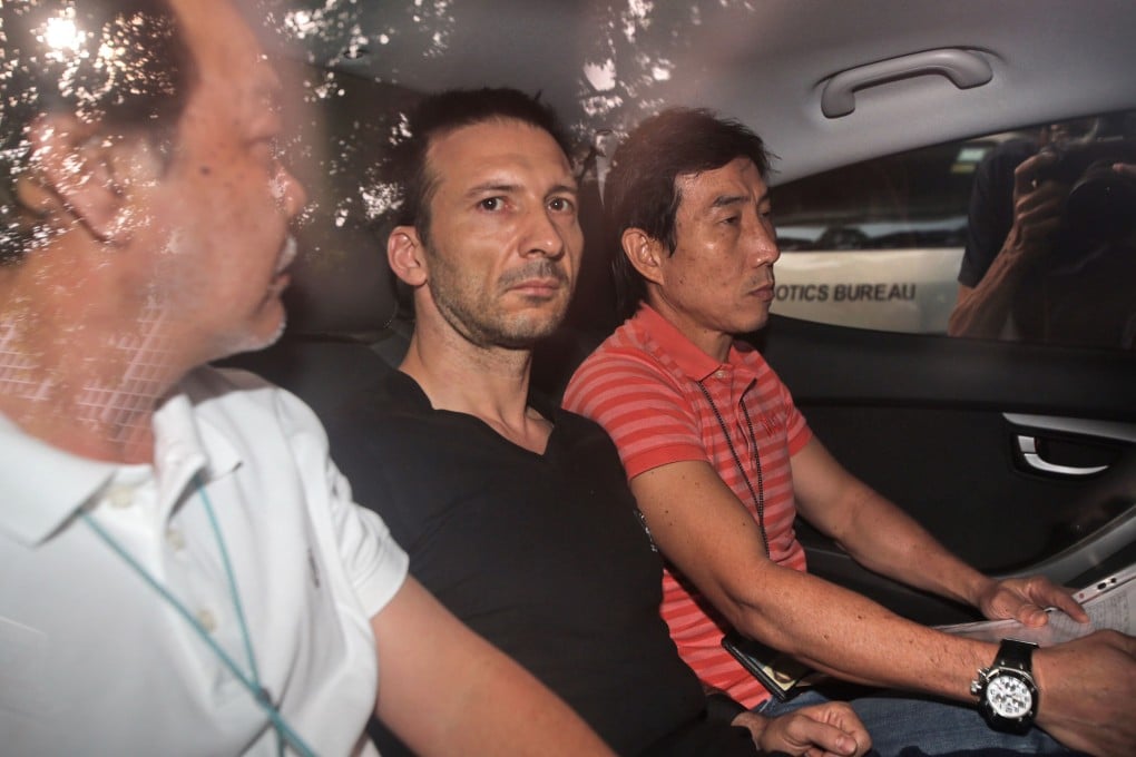 Belgian national Philippe Graffart (centre) arrives at the state court in Singapore. The 41-year-old financial executive was charged on Wednesday with murdering his 5-year-old son in Singapore, an offence punishable by hanging. Photo: AFP