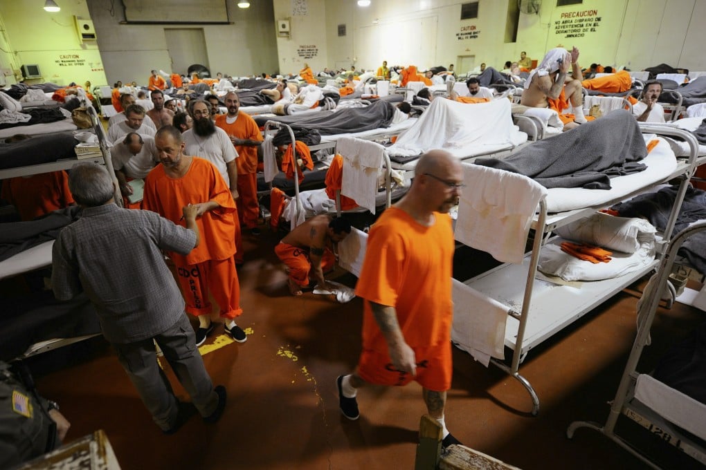 Inmates at a California state prison walk past their bunk beds in a gymnasium modified to house prisoners. The largest one-time release of federal prisoners starts this month in an effort to reduce overcrowding. Photo: AP