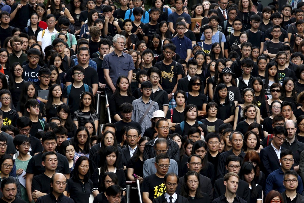 HKU staff and students stage a silent protest against the governing council's decision not to appoint Johannes Chan as a pro-vice-chancellor. Photo: Reuters