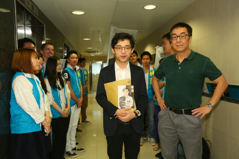 Joseph Lam Chok (centre) said he wants to change Hong Kong's 'deeply divided' society , starting with Wong Tai Sin district. Columnist Chip Tsao is on the right. Photo: Edmond So