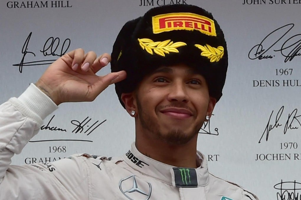 Mercedes' British driver Lewis Hamilton celebrates on the podium after winning the Russian Formula One Grand Prix. Photo: AFP