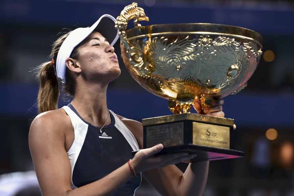 Spain's Garbine Muguruza kisses the winning trophy after her China Open title win in Beijing on Sunday. Hours later she pulled out of Hong Kong. Photo: Reuters