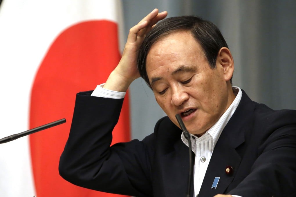 Japan's Chief Cabinet Secretary Yoshihide Suga holds a press conference after the arrest of two Japanese men on suspicion of spying. Photo:AP