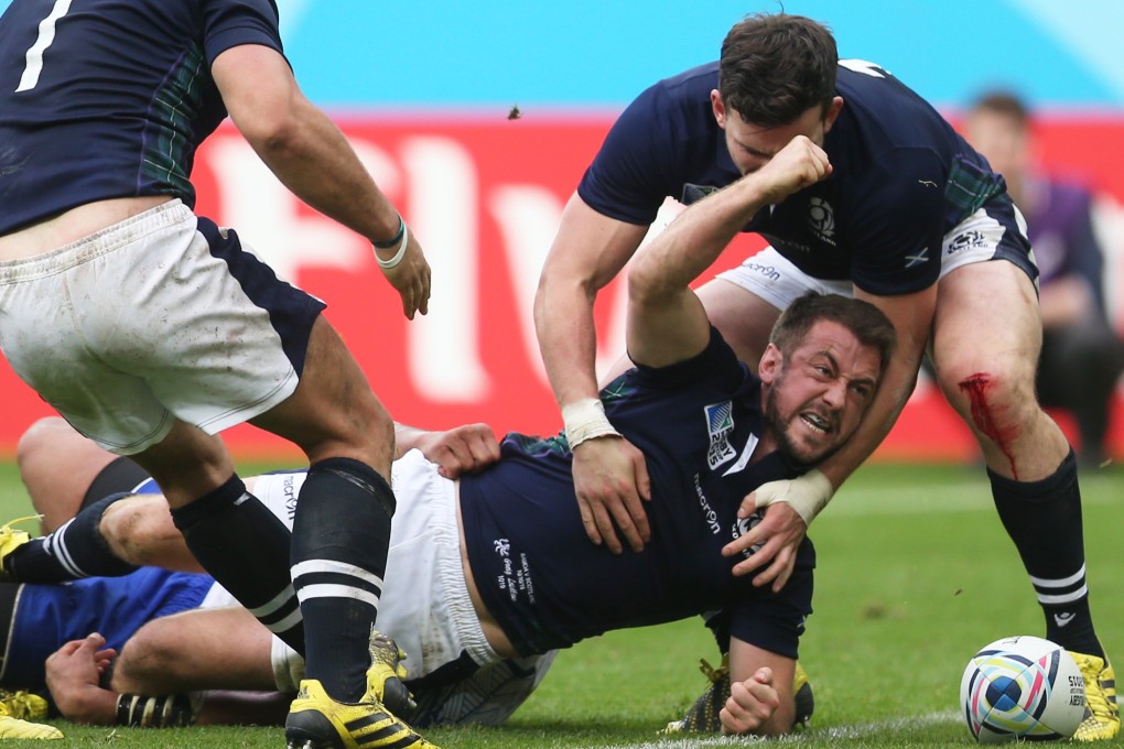 Scotland's Greig Laidlaw (centre) celebrates scoring his team's third try. Photos: Reuters