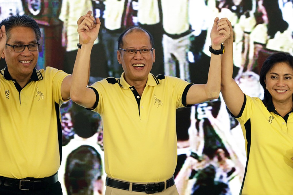 President Benigno Aquino (centre) raises the arms of his Interior Secretary Manuel ‘Mar’ Roxas and Congresswoman Maria Leonor Gerona Robredo during a political party gathering in San Juan city, eastern Manila. Photo: EPA