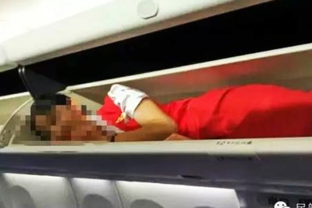 Pictures of cabin crew at Kunming Airlines forced into luggage lockers went viral after they were posted online. Photo: Sina.com