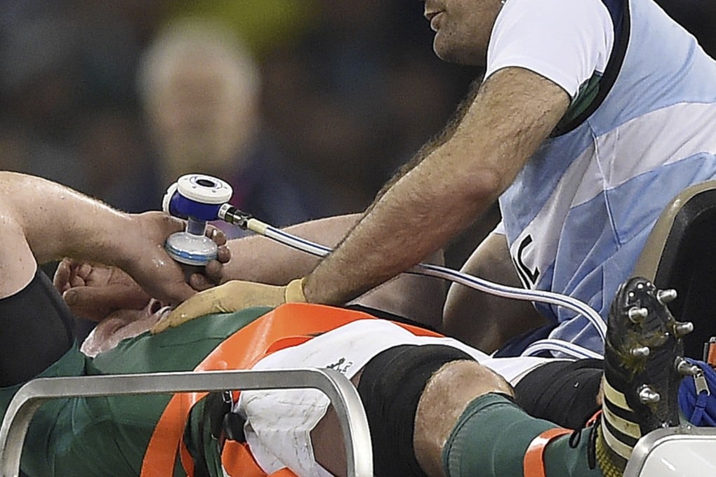 Paul O'Connell takes oxygen as he is stretchered off. Photo: AFP