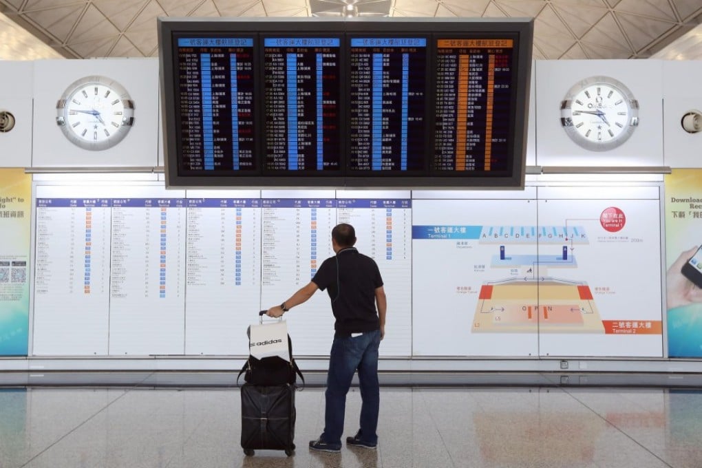 A traveler waiting at the Hong Kong airport (Photo: Sam Tsang/SCMP)