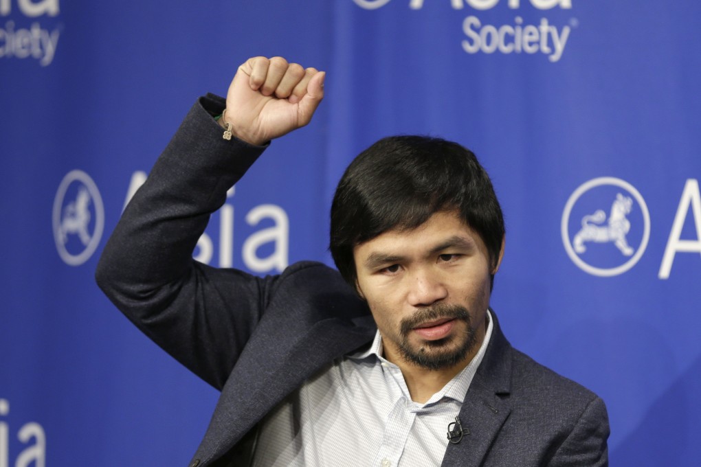 Manny Pacquiao demonstrates the extent to which his surgically repaired shoulder has healed. Photo: AP