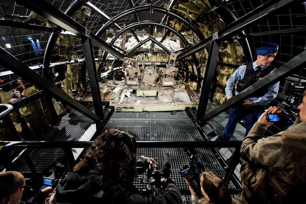 A view of the rebuilt cockpit section of the rebuilt fuselage of Malaysia Airlines flight MH17, just before the Dutch report was released on Tuesday. Photo: EPA