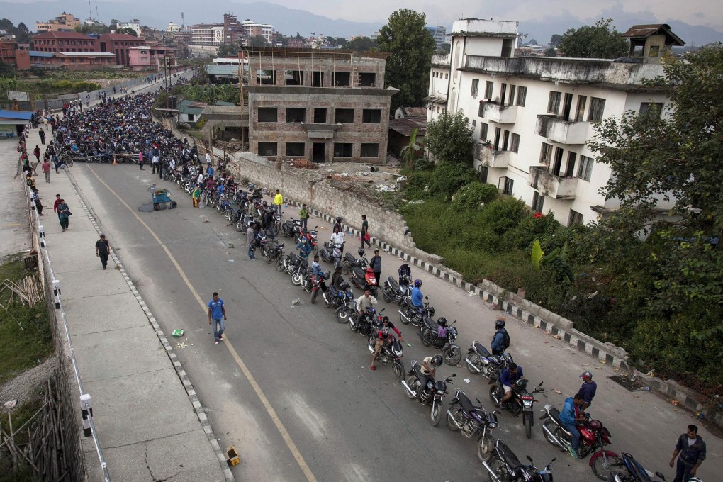 Nepalese motorcyclists queue up at a petrol station in the capital Kathmandu as the pumps distributed fuel for the first time in weeks.Photo: EPA