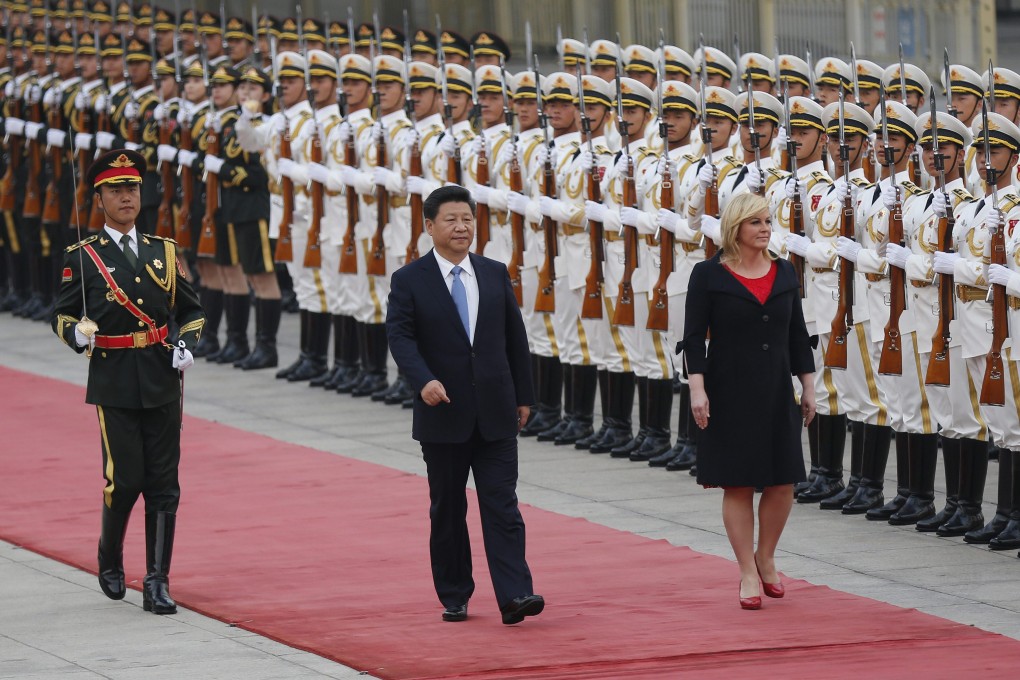 President Xi Jinping walks past an honor guard with Croatian President Kolinda Grabar-Kitarovic in Beijing on Wednesday.  Xi has called for new mechanisms and rules to govern global political and economic cooperation. Photo: EPA