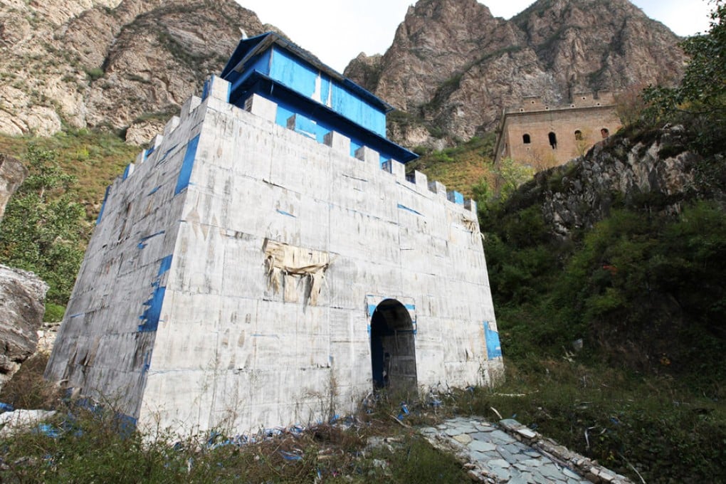 The film-set Great Wall beacon tower, which blocks the view of the real one in the background, was abandoned by a television crew in June. Photo: Xinhua